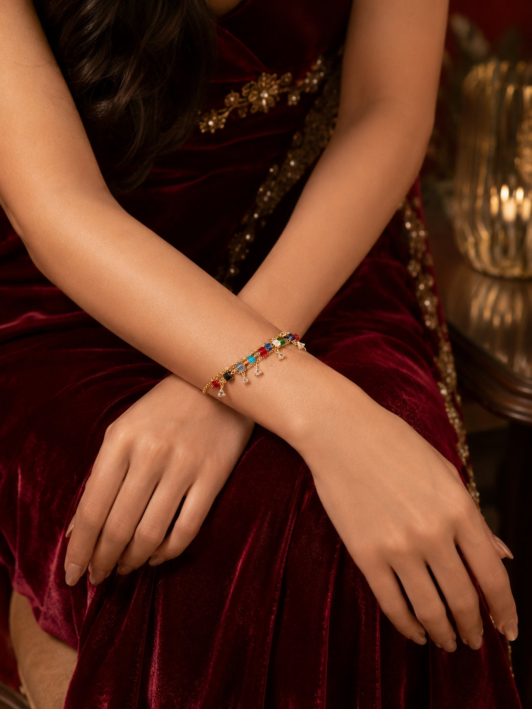 Model wearing gold crystal stone bracelet with colourful cube beads in ethnic outfit