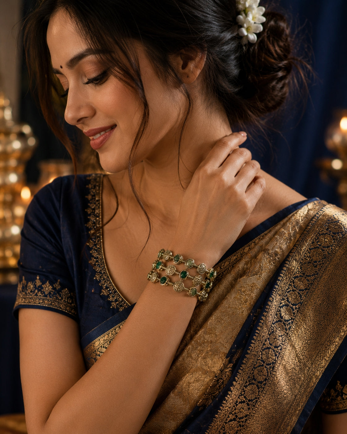 Model wearing emerald green bangle set with ivory saree and green blouse