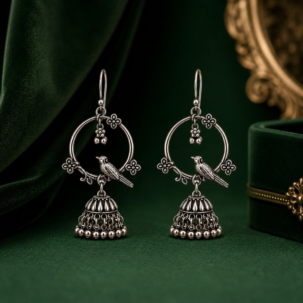 Oxidised silver bird jhumka earrings on dark green velvet with jewellery box