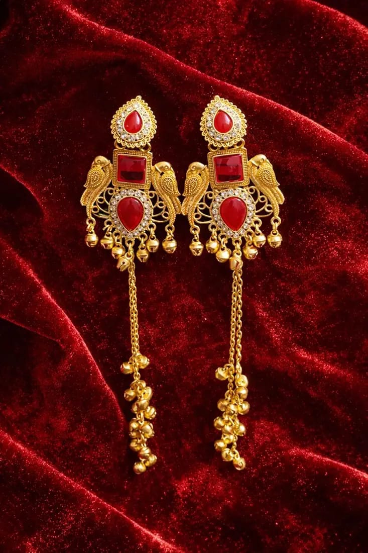 Kashmiri gold jhumka earrings with red stone on red velvet
