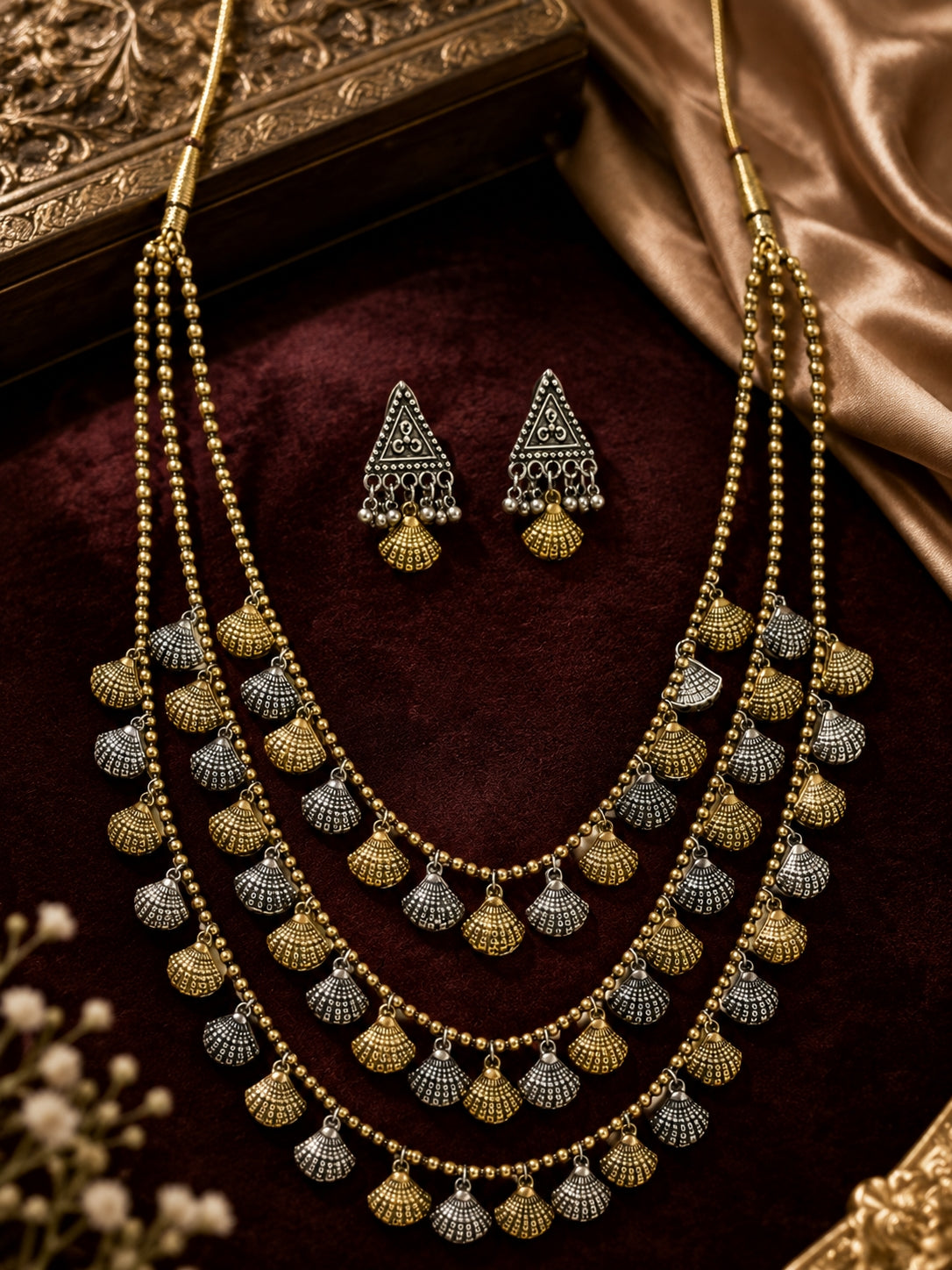 Handcrafted brass jewellery set on wood