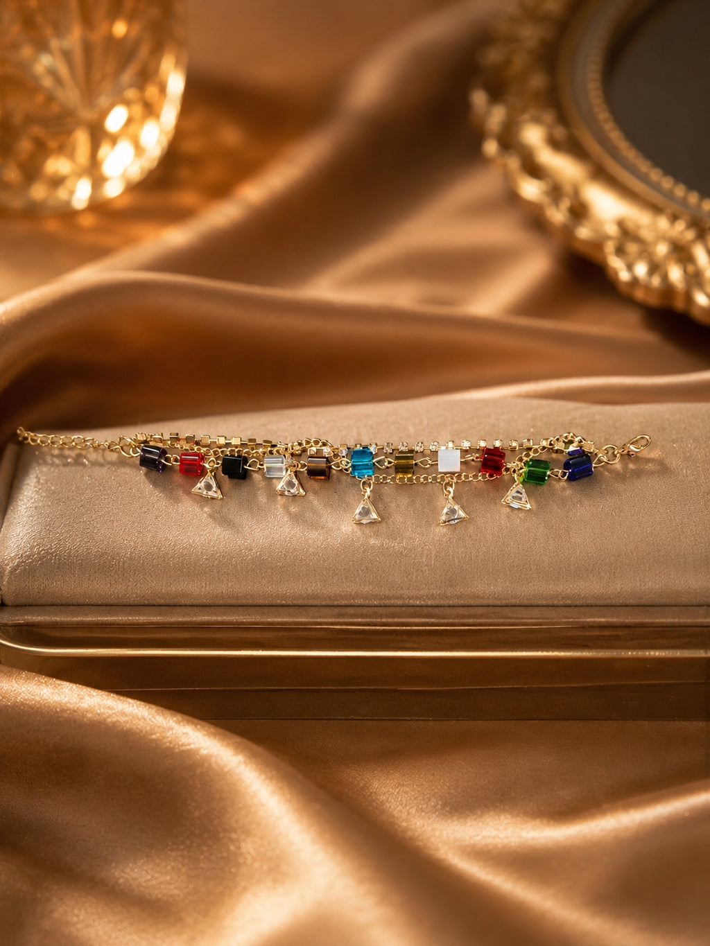 Gold-toned multicolour crystal cube bracelet with triangle CZ charms on gold satin jewellery box
