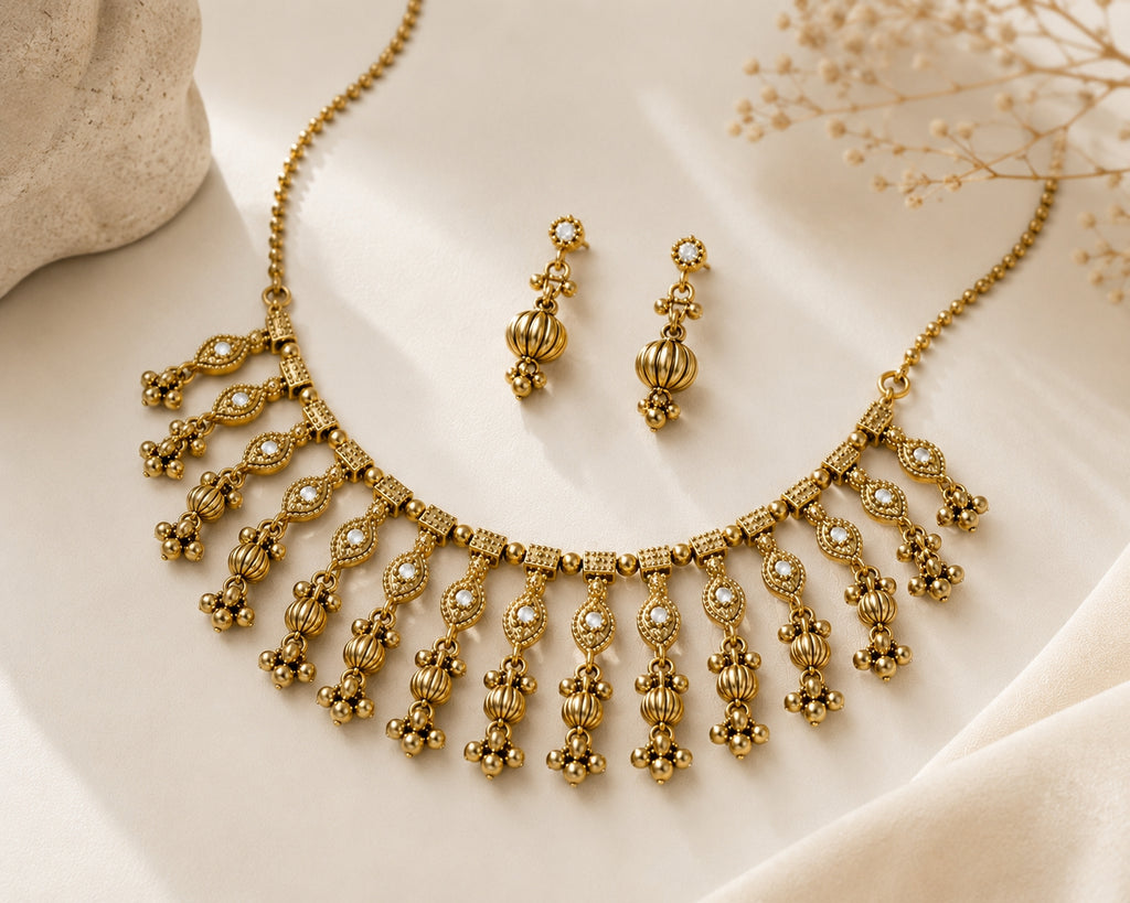Antique gold choker necklace set on golden silk fabric