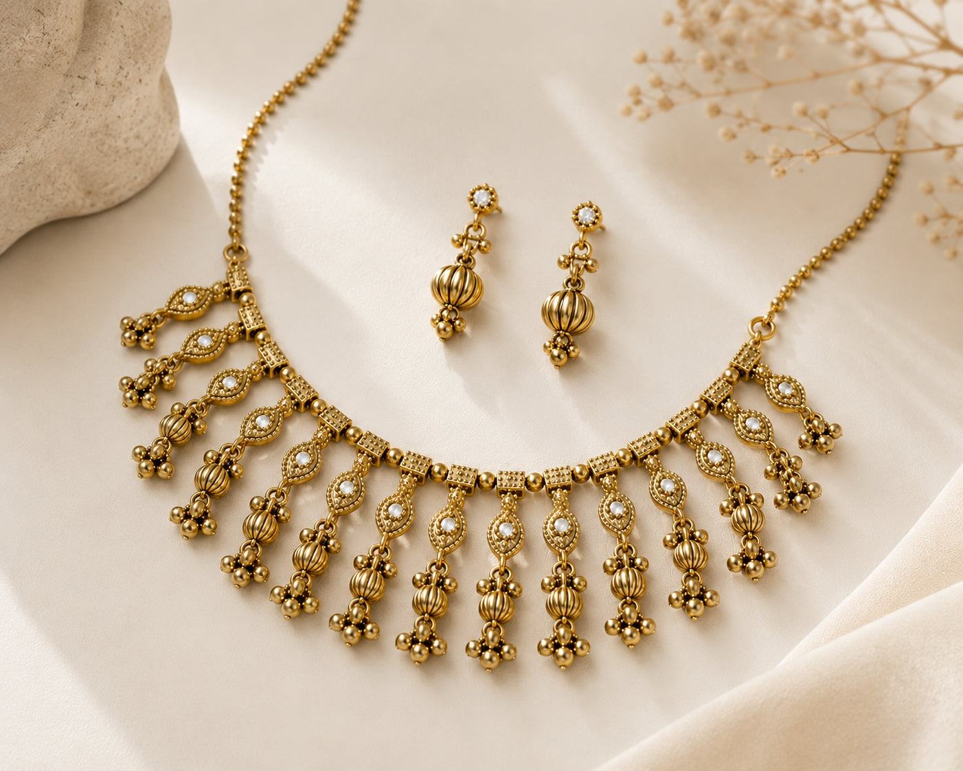 Antique gold choker necklace set on golden silk fabric