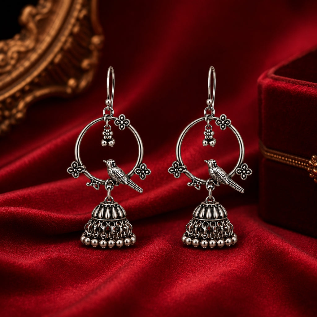 Oxidised silver bird jhumka earrings on red velvet with jewellery box