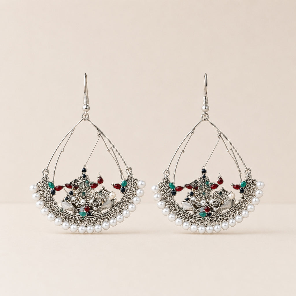 Oxidised silver Kashmiri chandbali earrings with pearl border on cream background