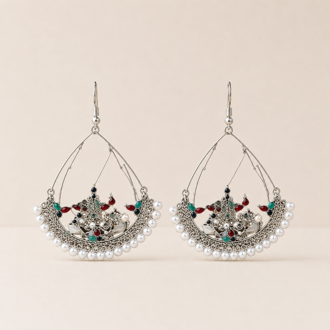 Oxidised silver Kashmiri chandbali earrings with pearl border on cream background