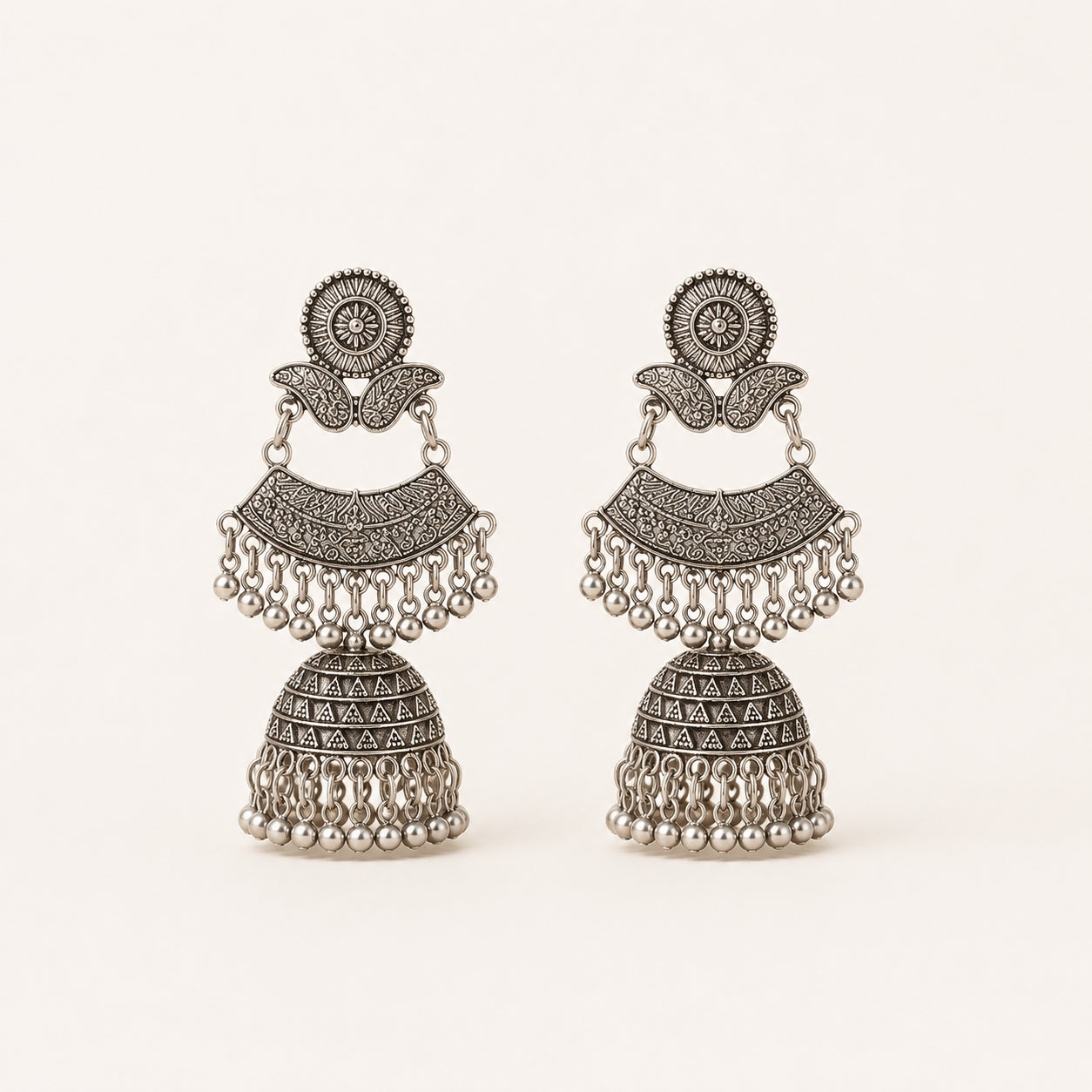 Oxidised silver double decker jhumka earrings on white background