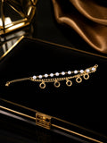 Gold-toned pearl and circle charm layered bracelet on black velvet jewellery box