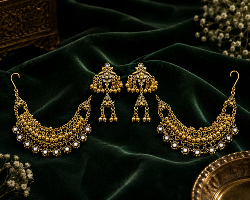 Antique Gold Bugadi Jhumka Earrings on dark velvet