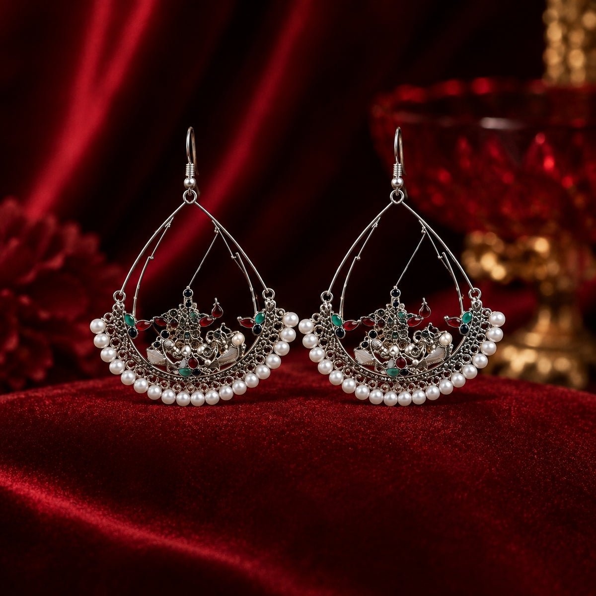 Oxidised silver Kashmiri chandbali earrings with pearl border on red velvet