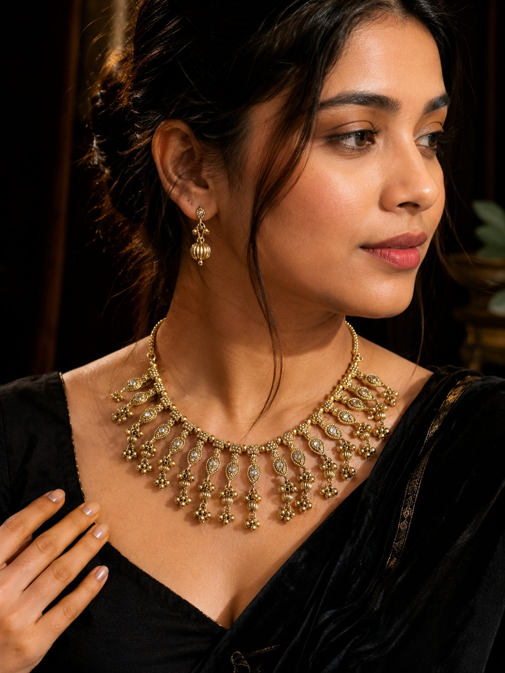 Model wearing antique gold choker necklace set with jhumki earrings